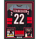 Framed Autographed/Signed Logan Stankoven 35x39 Carolina Black Jersey BAS COA