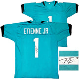 JAGUARS TRAVIS ETIENNE AUTOGRAPHED SIGNED TEAL JERSEY BECKETT WITNESS 220896