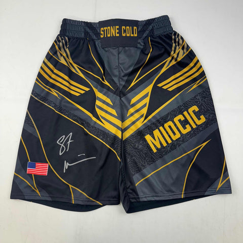 Autographed/Signed Stipe Miocic Black Gold UFC MMA Trunks Shorts BAS COA