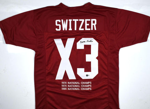Barry Switzer Autographed Maroon College Style Stat Jersey - Beckett W Hologram