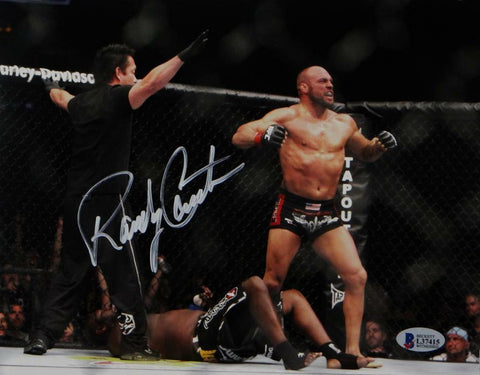 Randy Couture Signed UFC 8x10 Photo With Belt- Beckett Auth *Ref Facing Couture